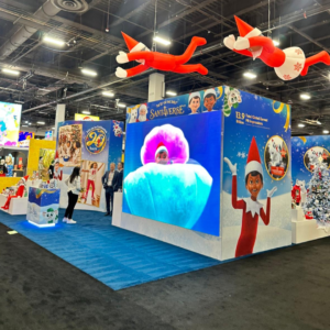 An image of an event stand with various images of Christmas elf characters.