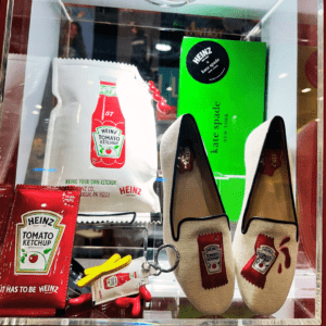 Display case with fashion merchandise branded with Heinz Ketchup imagery.