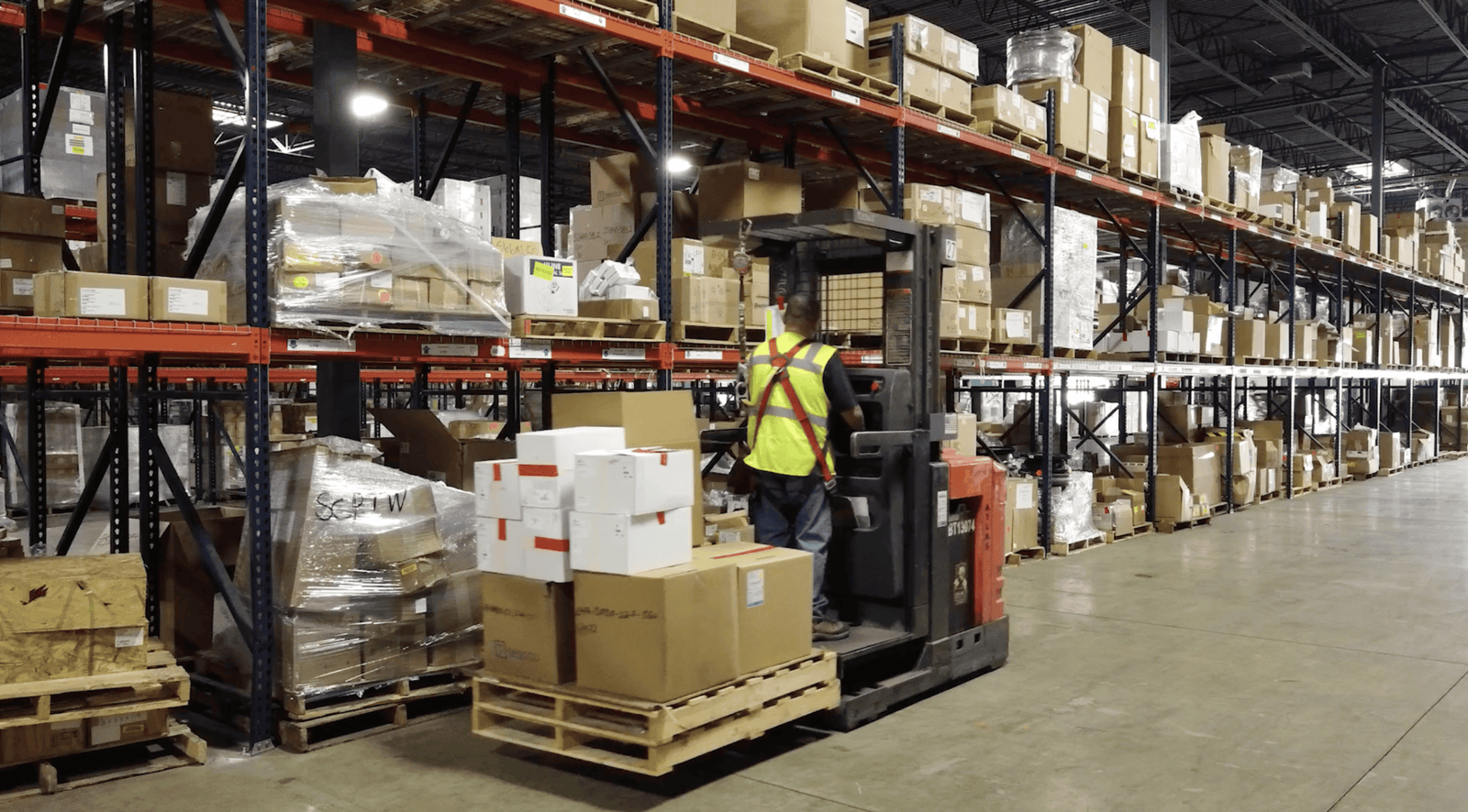 Warehouse operator in high vis jacket.